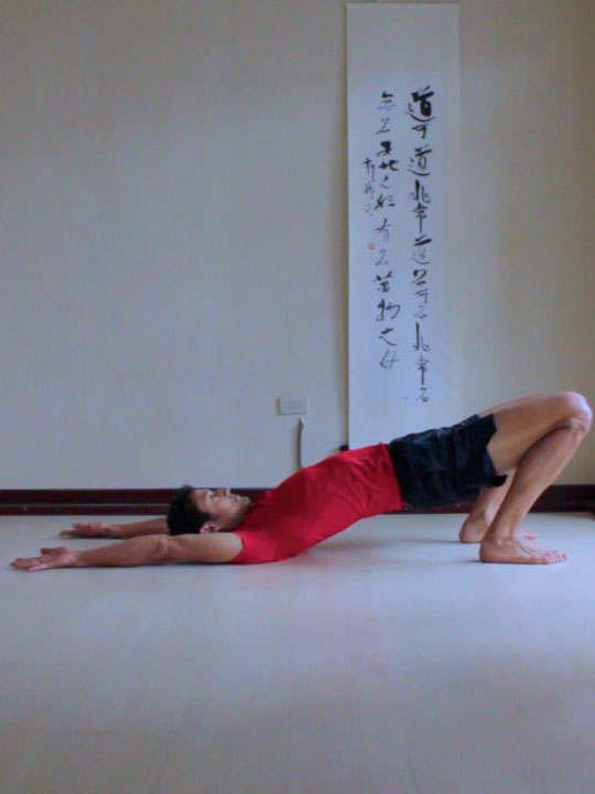 bridge pose with arms back, using legs to pull hips forwards.