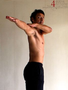Arm to the side active shoulder stretch, pulling one arm back while holding on to upper arm with other hand, neil keleher, sensational yoga poses.