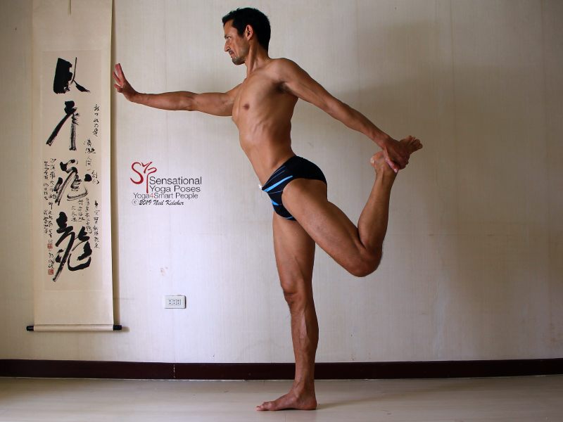 Sensational Yoga Poses, Model Neil Keleher. Balancing on one foot while upright in dance pose or or standing bow with the same side hand grabbing the lifted foot behind the body.