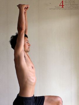Arm overhead shoulder stretch, hands clasped and palms pressing upwards, neil keleher, sensational yoga poses.
