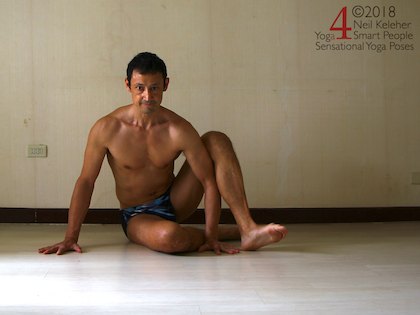 Astavakrasana preparation exercise, sitting with one arm resting against the back of one arm. Neil Keleher. Sensational Yoga Poses.