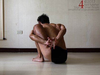 Binding in marichyasana a with arm pressing back against the shin. Neil Keleher. Sensational Yoga Poses.
