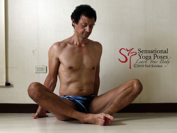 Bound angle foot press, prep for side angle pose. Neil Keleher. Sensational Yoga Poses.