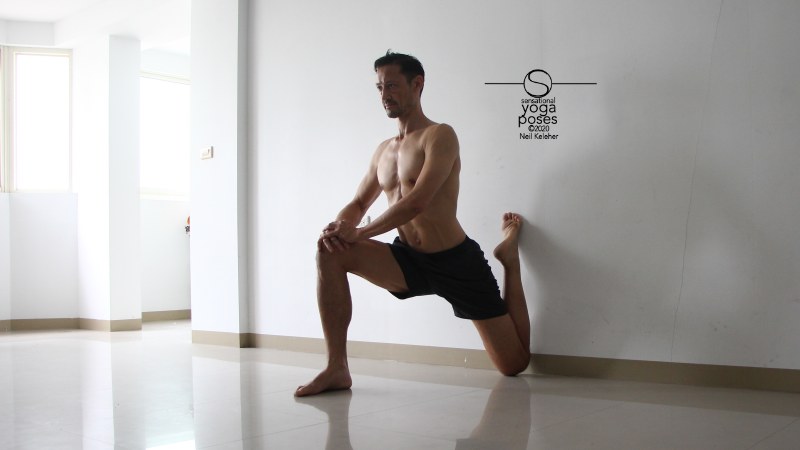 quad stretch using a wall with hips forwards and torso upright. Neil Keleher, Sensational Yoga Poses.