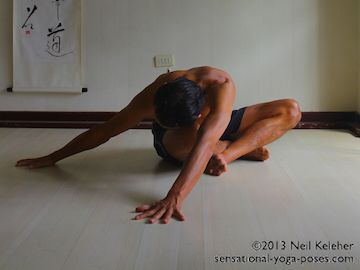 Bending forwards and then bending to one side while sitting cross legged. Neil Keleher. Sensational Yoga Poses.