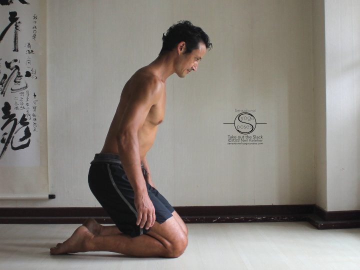 Shift your weight rearwards so that your feet press down while kneeling with hips lifted.