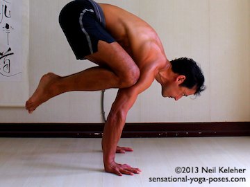To get your feet off the ground for crow pose, shift your weight forwards so that your knees press into your arms and so that your hands press down with maximum pressure.