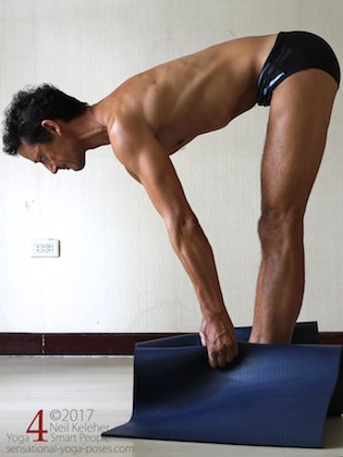 Arm strengthening standing forward bend:  Grabbing your yoga mat and pulling upwards. Neil Keleher. Sensational Yoga Poses.