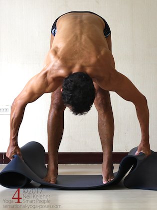 Arm strengthening standing forward bend:  Grabbing your yoga mat and pulling outwards. Neil Keleher. Sensational Yoga Poses.