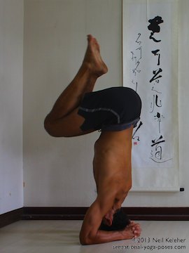 inverted yoga pose, balancing in headstand while using the wall