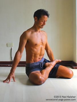 pulling foot into lotus with other leg in kneeling position as a preparation for marichyasana b, bharadvajasana leg position