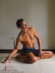 easy bharadvajasana side bend (towards kneeling leg) with hand resting on the floor.