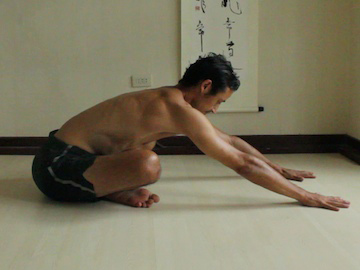 easy seated forward bend (legs crossed) hands on the floor, torso slightly upright