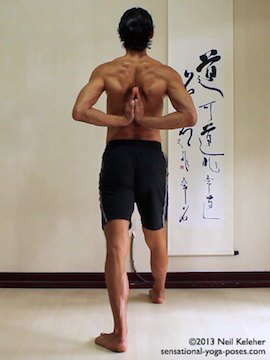 ashtanga yoga poses, utthitta Purvottanasana, hands in prayer. In this picture the right leg is forwards and the left leg back with both knees straight. Torso is upright and hands are together in prayer behind the back.