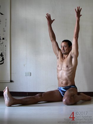half hero yoga pose upright quad stretch, sitting with spine long and reaching arms upwards.
