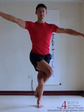 preparation for eagle pose, arms to the side, one arm higher