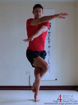 preparation for eagle pose, arms cross one over the other, elbows still striaght.
