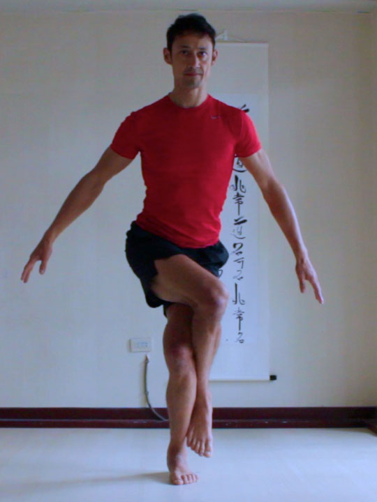 preparation for eagle pose, rolling thigh inwards with legs crossed and hip lifted