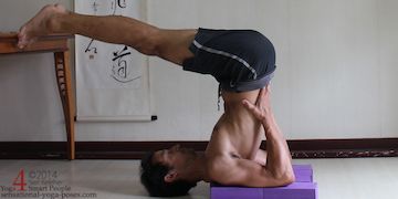 plough pose with feet on a table