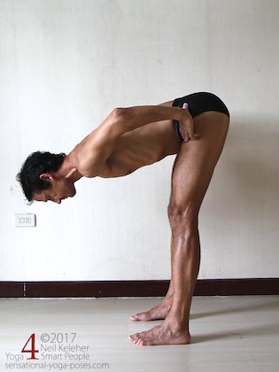 Standing forward bend with hands on waist. Neil Keleher. Sensational Yoga Poses.