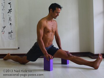 moving into splits with hands on yoga blocks front knee straight back knee on floor