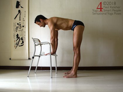 Standing forward bend with hands on chair and arms bearing weight of upper body. Neil Keleher. Sensational Yoga Poses.