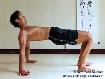 In table top back bending yoga pose, start in a seated position with hands on the floor behind you. Squeeze shoulder blades together and open the chest. Then press feet into the floor to lift the pelvis. Position feet so that shins and arms are all vertical.