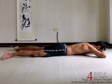 makrasan or crocodile resting posture with forehead resting on hands. Neil Keleher sensationa yoga poses.